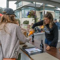 Volunteer serving mimosas and wine